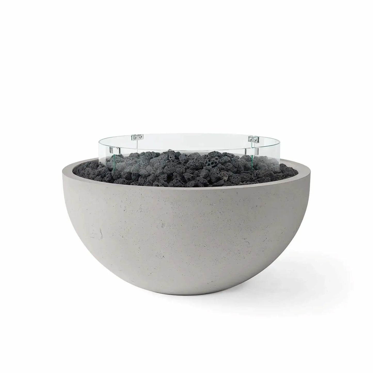 HPC Fire Hearth Products Controls Dekko GFRC Concrete Serenade 32 Fire Pit in Sandstone finish featuring black lava rock media and a circular tempered glass wind guard. The warm-toned GFRC concrete fire bowl contrasts beautifully with the volcanic rock fill, delivering a clean contemporary aesthetic perfect for outdoor patios, poolside gathering areas, and modern backyard living spaces.