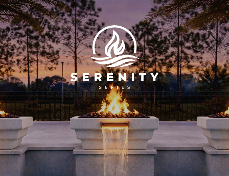 Outdoor fire pit landscape feature with three rectangular stone planters in a row, each containing a flame and a central waterfall feature flowing into a pool. Tall trees and a fence are visible in the background under a twilight sky.