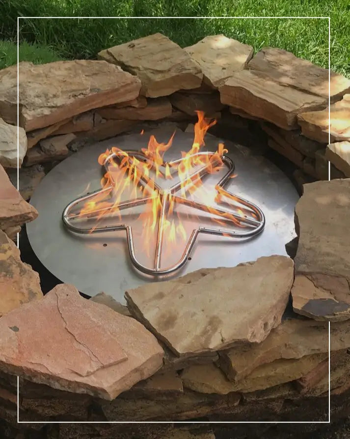 Durable stainless steel fire pit burner with a crossfire design, set in a rustic stone fire pit for efficient outdoor heating and ambiance.