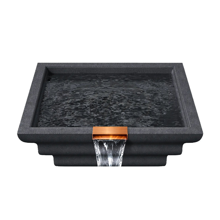 Top view of the graphite Serenity Series ripple square water bowl filled with water, displaying rippling surface reflections inside the geometric basin. A copper spillway at the front edge releases a steady waterfall stream, emphasizing the bowl’s function as a decorative pool water feature designed for modern outdoor living spaces.