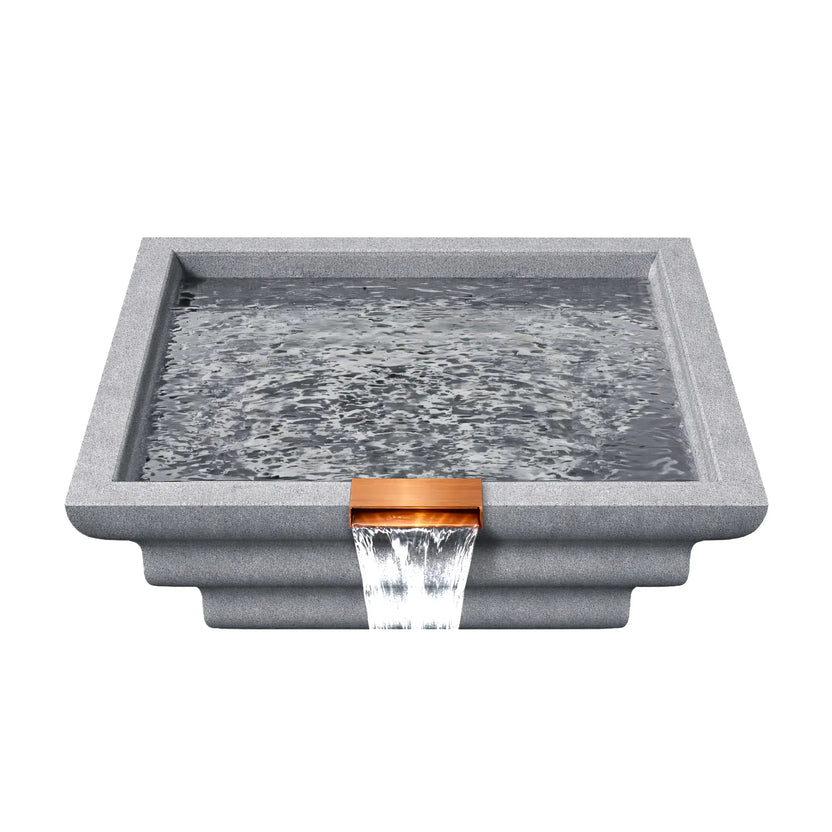 Top view of the gray Serenity Series ripple square water bowl filled with water, showing the reflective basin surface and copper spillway outlet along the front edge. Water gently ripples inside the square bowl before spilling over the scupper to create a smooth waterfall feature designed for luxury pool landscapes.
