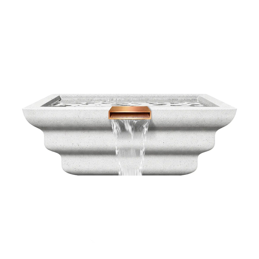 Front-facing view of the Serenity Series square ripple water bowl in white, showcasing the centered copper scupper spillway and sculpted ripple-style exterior profile. Water flows evenly from the rectangular spillway, forming a clean waterfall cascade. The minimalist white finish and layered bowl design complement modern pool and spa water feature installations.