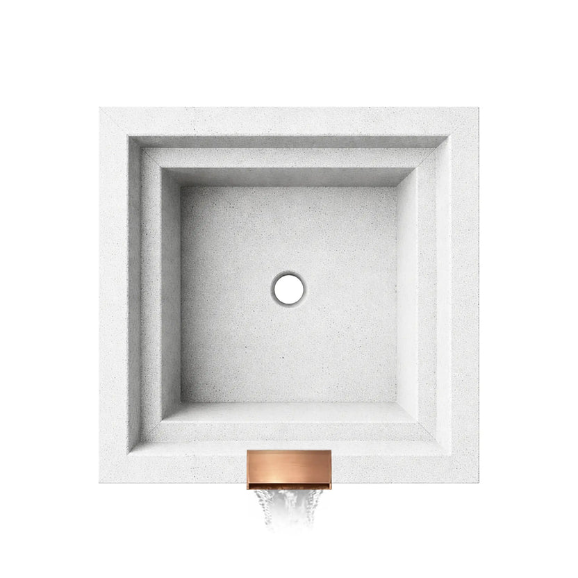 Top-down view of the Serenity Series ripple square water bowl in white, displaying the empty interior basin and centered drain opening. The stepped square walls and smooth textured finish highlight the geometric design, while the copper spillway outlet at the front edge indicates where water exits to form a decorative waterfall feature.