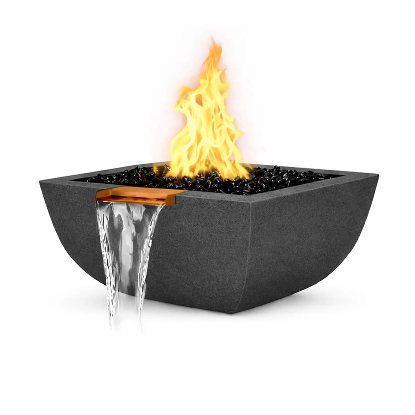 Black GFRC concrete square rounded fire and water bowl with a live gas flame burning above glossy black fire glass. A copper spillway integrated into the bowl releases a clear waterfall that flows smoothly downward. The textured dark finish and curved bowl profile highlight the modern Serenity Series fire and water feature design.