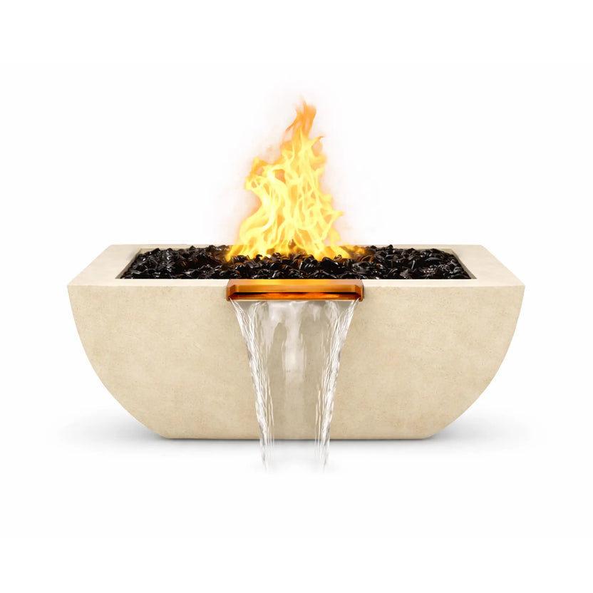 Front view of the white Serenity Series square curved fire and water bowl with a bright gas flame rising above black fire glass. A copper spillway centered on the front edge pours a continuous waterfall stream downward, emphasizing the bowl’s balanced fire and water display.