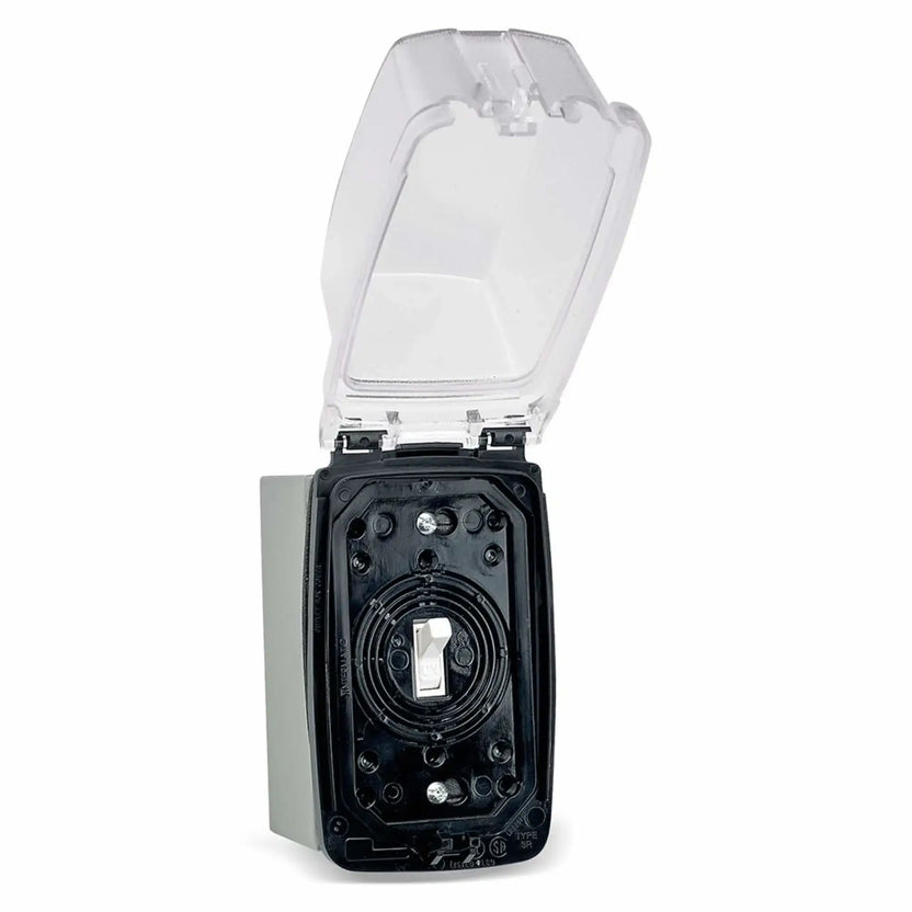 Open weatherproof outdoor electrical box revealing a standard white ON/OFF toggle wall switch inside, protected by a hinged transparent cover and rugged gray housing for exterior electronic ignition installations.