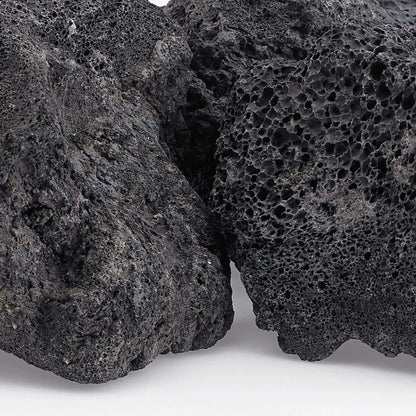 Close-up view of extra extra large lava rock revealing dense volcanic vesicles, rough texture, and natural dark gray coloration with subtle mineral variations.