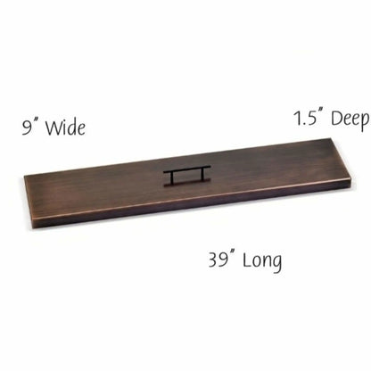 36-inch linear oil rubbed bronze fire pit burner cover with a flat rectangular profile, brushed bronze finish, and centered handle for clean coverage of narrow fire pit openings.