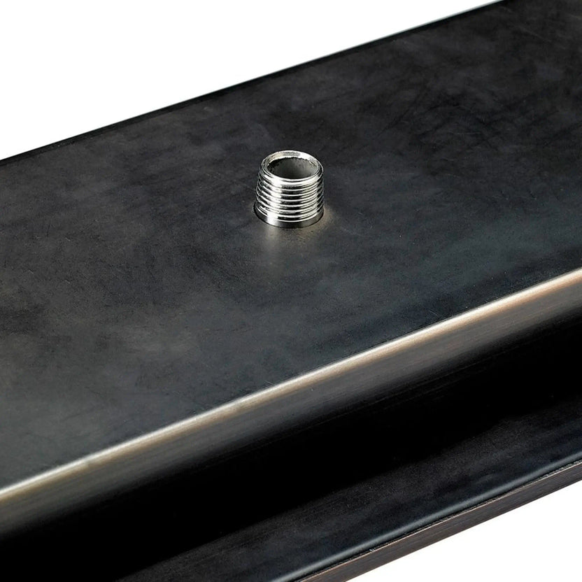 Close-up detail of the underside gas inlet nipple on an oil rubbed bronze linear drop-in burner pan from American Fire Products, highlighting the threaded gas connection used for secure outdoor fire pit installations.
