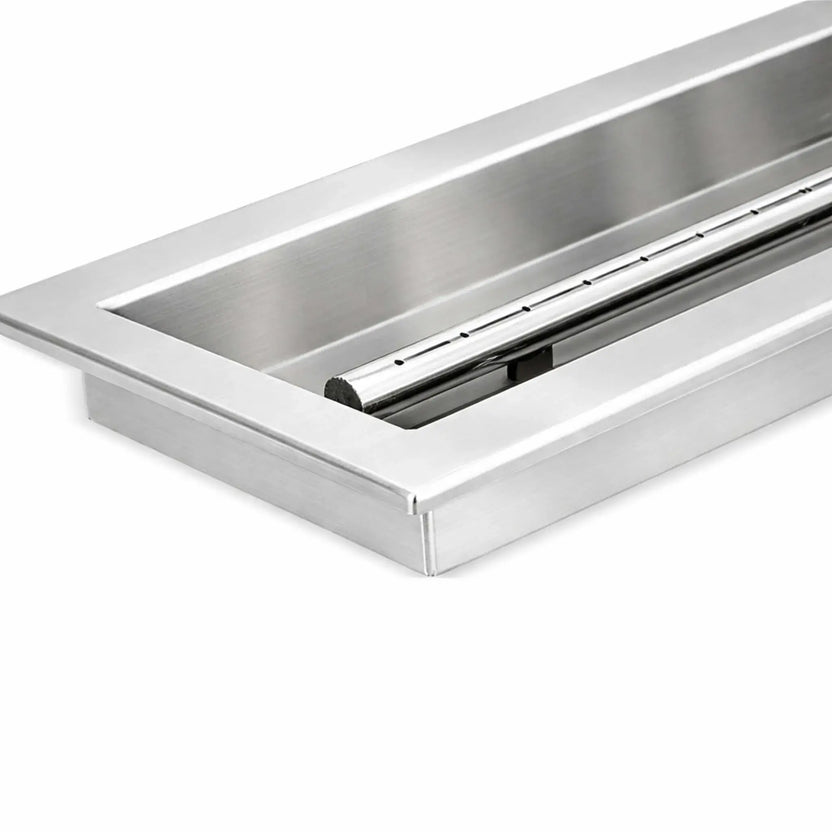Close-up view of the corner on a stainless steel linear drop-in burner pan, showing the clean folded edges, brushed metal finish, and precision-welded construction designed for long-term outdoor fire pit installations.