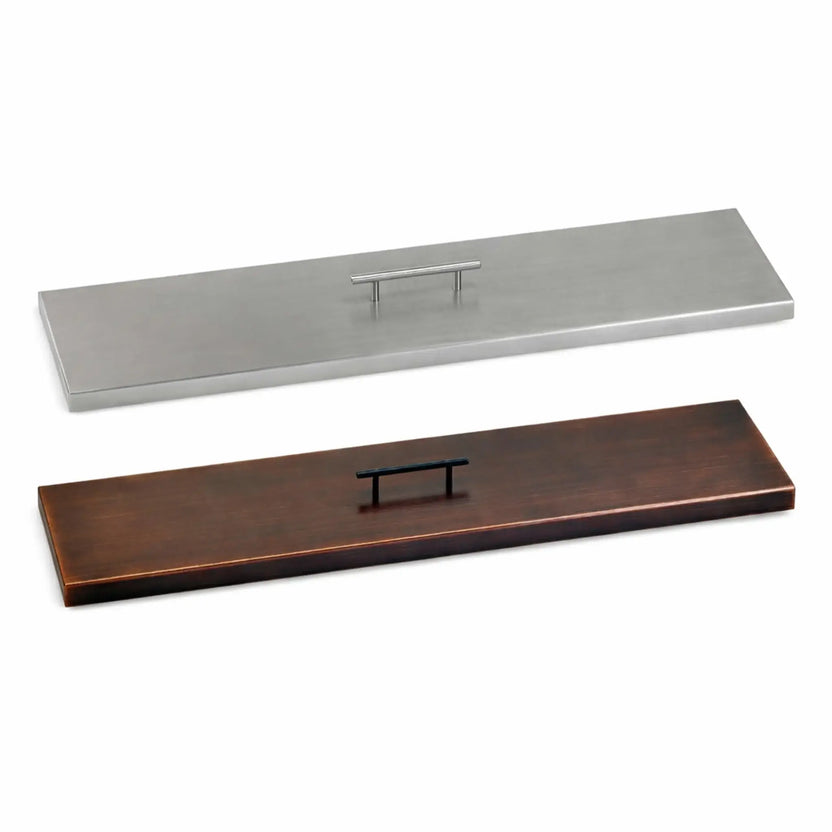 Side-by-side comparison of linear fire pit burner covers in stainless steel and oil rubbed bronze finishes, highlighting the contrast between modern silver tones and warm bronze styling for outdoor fire features.