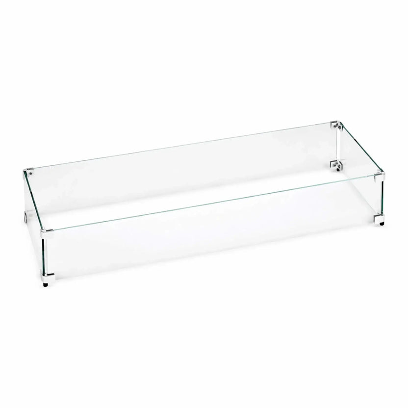 Linear tempered glass wind guard designed for rectangular fire pits, featuring clear glass panels secured with metal corner brackets, shown assembled to protect flames from wind while maintaining an open, modern look.