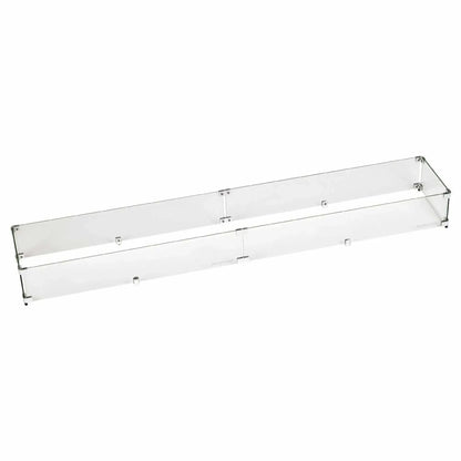 Long linear tempered glass wind guard constructed with clear glass panels and stainless mounting hardware, designed to sit around large rectangular fire pits for improved flame stability in windy conditions.