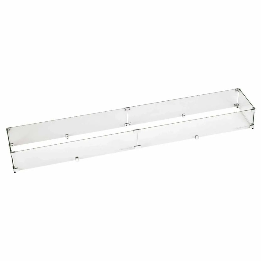 Long linear tempered glass wind guard constructed with clear glass panels and stainless mounting hardware, designed to sit around large rectangular fire pits for improved flame stability in windy conditions.
