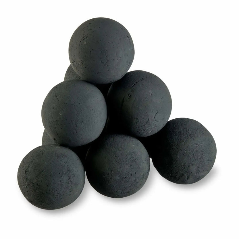 Studio product photo of six matte black 4-inch fire balls stacked in a pyramid on a white background, showing the textured, stone-like finish.