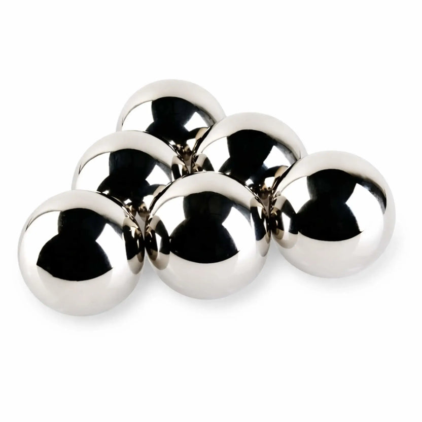 Set of six 4-inch stainless steel fire balls with a polished mirror finish, reflecting light and surroundings, photographed on a white background for a clean, modern product presentation.