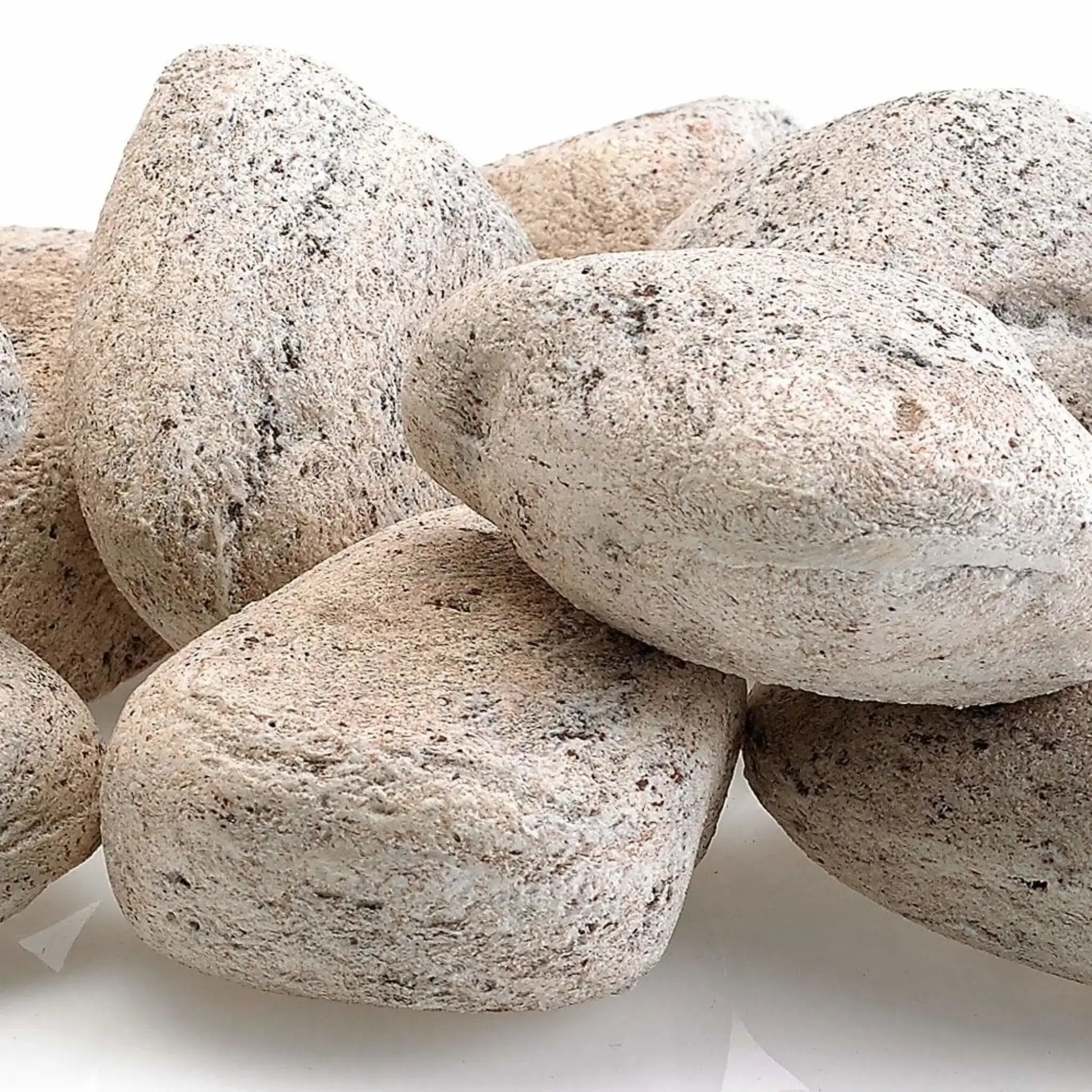 Close-up of Cottage White Lite Stones by American Fire Products showing smooth rounded shapes, light off-white coloring, and natural speckled texture designed for use in gas fire pits and fireplaces.