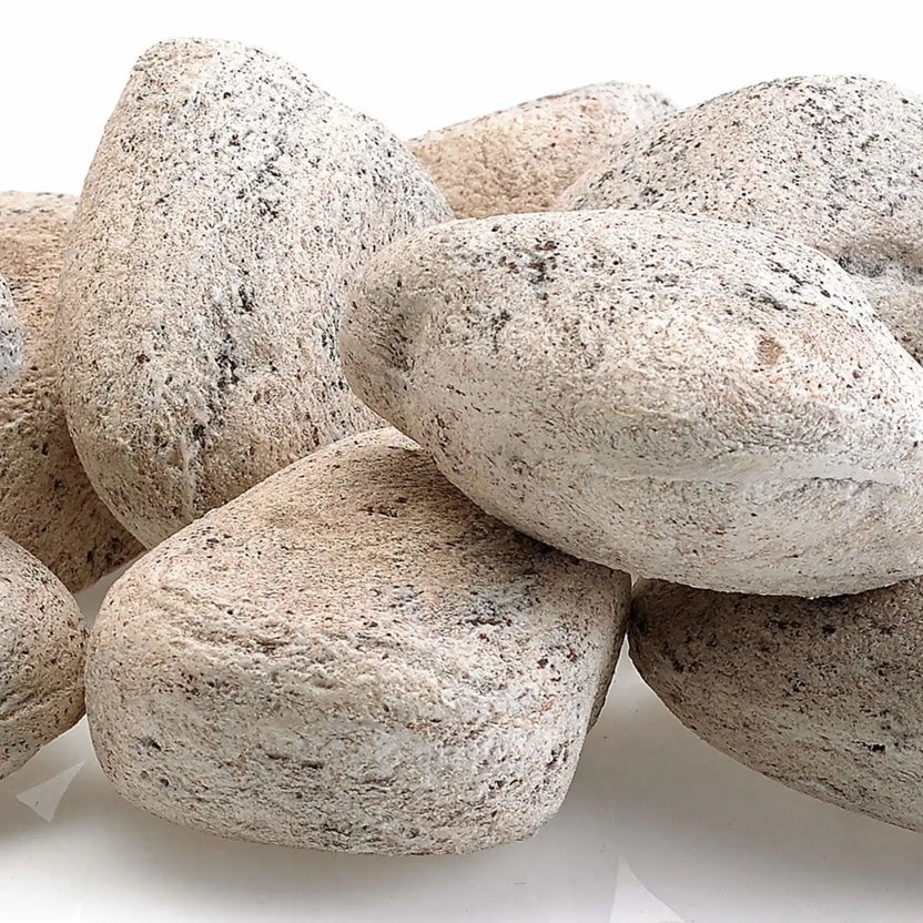Close-up of Cottage White Lite Stones by American Fire Products showing smooth rounded shapes, light off-white coloring, and natural speckled texture designed for use in gas fire pits and fireplaces.