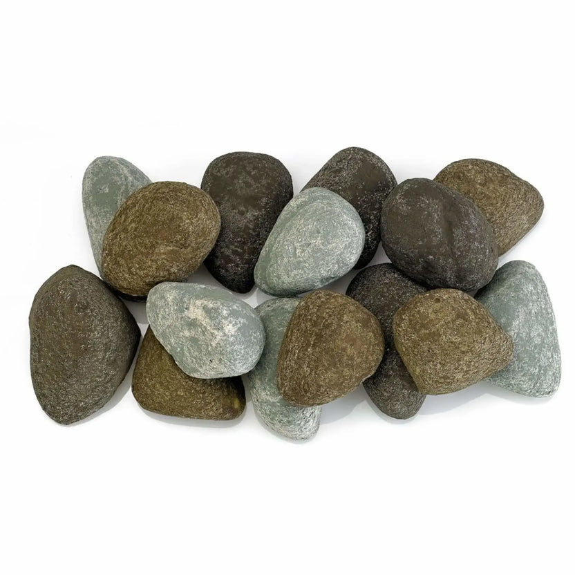 Top view of Natural Lite Stones by American Fire Products arranged across a linear fire pit burner, featuring a blend of brown, gray, and soft blue-gray stones with smooth rounded shapes.