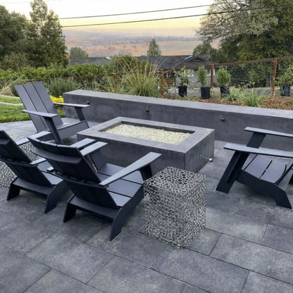 Outdoor patio fire pit installation using a polished chrome eight inch universal gas key, shown in a modern backyard setting with a rectangular fire pit surrounded by contemporary seating and stone hardscape.