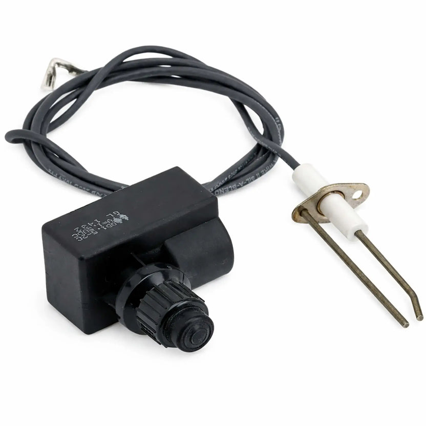 Push button spark ignition kit for gas fire pits and fireplaces, featuring a black rectangular ignition module with a manual push button, attached wiring, and a ceramic electrode with mounting bracket designed to create a reliable spark for lighting outdoor gas burners.