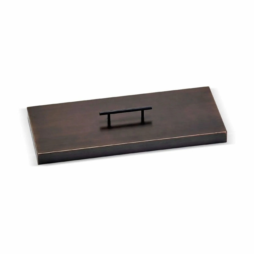 Rectangular oil rubbed bronze fire pit burner cover with a low-profile design and centered lift handle, crafted to protect gas burners while providing a finished tabletop surface when the fire feature is not in use.