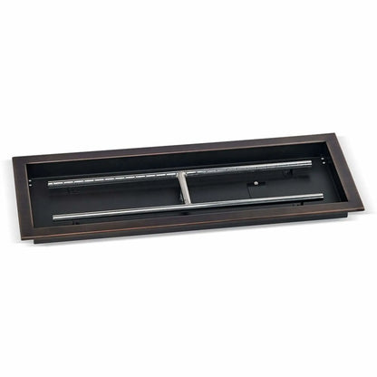 Large oil-rubbed bronze rectangular drop-in burner pan measuring 30 by 10 inches, displayed at an angle to highlight the deep pan construction, stainless steel burner bars, and mounting flange for outdoor fire tables.