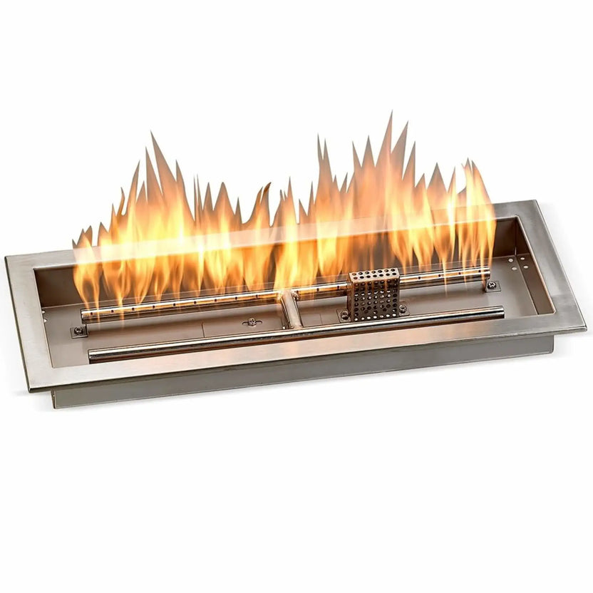 Rectangular 24-inch by 8-inch stainless steel drop-in fire pit pan shown lit with a steady linear flame, featuring a brushed steel finish, raised installation lip, internal burner tube, and perforated flame guard producing an even fire pattern.