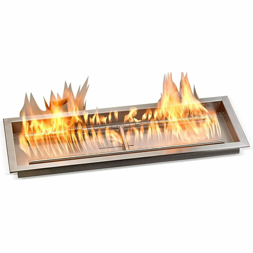 36-inch by 12-inch stainless steel drop-in fire pit pan shown in use with a full linear flame display, showcasing the long burner assembly, centered flame guard, and professional-grade construction designed for outdoor fire pit installations.