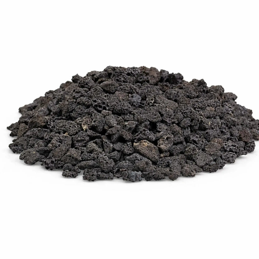 Pile of small black lava rock pieces with porous, lightweight texture, ideal for use as a natural gas fire pit base layer or decorative filler for outdoor fireplaces.