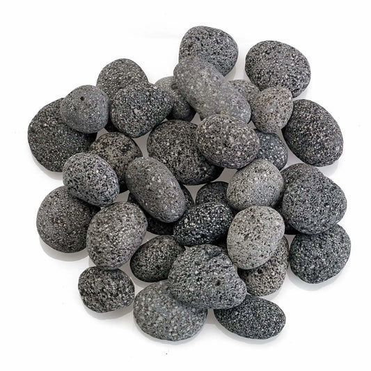 Top-down view of small American Fire Products lava stones clustered together, highlighting their compact size, smooth rounded edges, and naturally porous gray volcanic texture.