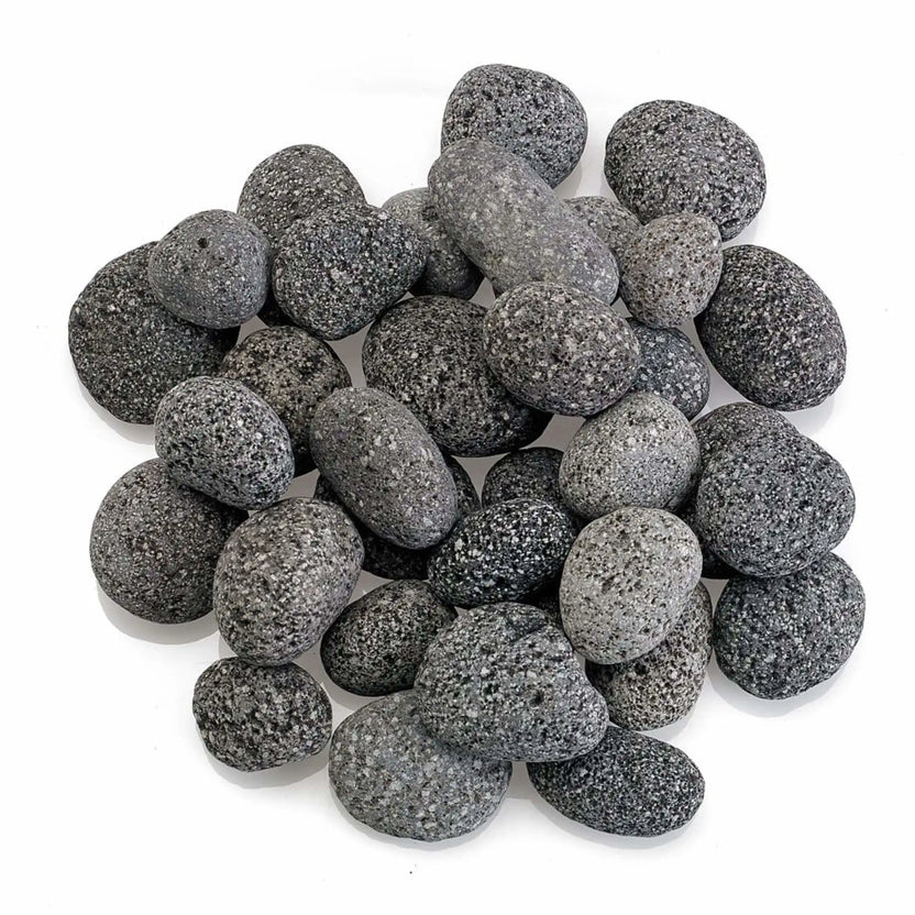 Top-down view of small American Fire Products lava stones clustered together, highlighting their compact size, smooth rounded edges, and naturally porous gray volcanic texture.