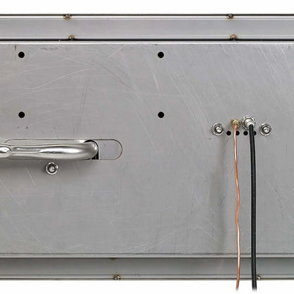 Bottom view of a stainless steel linear drop-in fire pit pan showing the underside construction, mounting hardware points, and gas and ignition line connections. The image highlights the reinforced stainless steel base, pre-drilled access holes, and wiring ports used for CSA-certified installation in outdoor fire features.