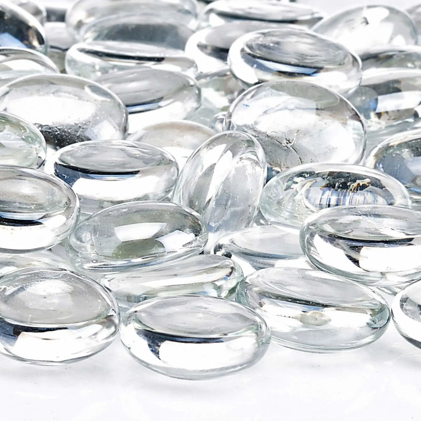 Detailed close-up of glacier ice fire glass beads featuring smooth polished edges, transparent tempered glass material, and reflective surfaces that catch and refract light.