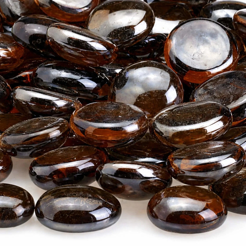 Close-up of root beer brown luster fire glass beads highlighting their rich translucent amber color, smooth rounded edges, tempered glass construction, and reflective sheen.
