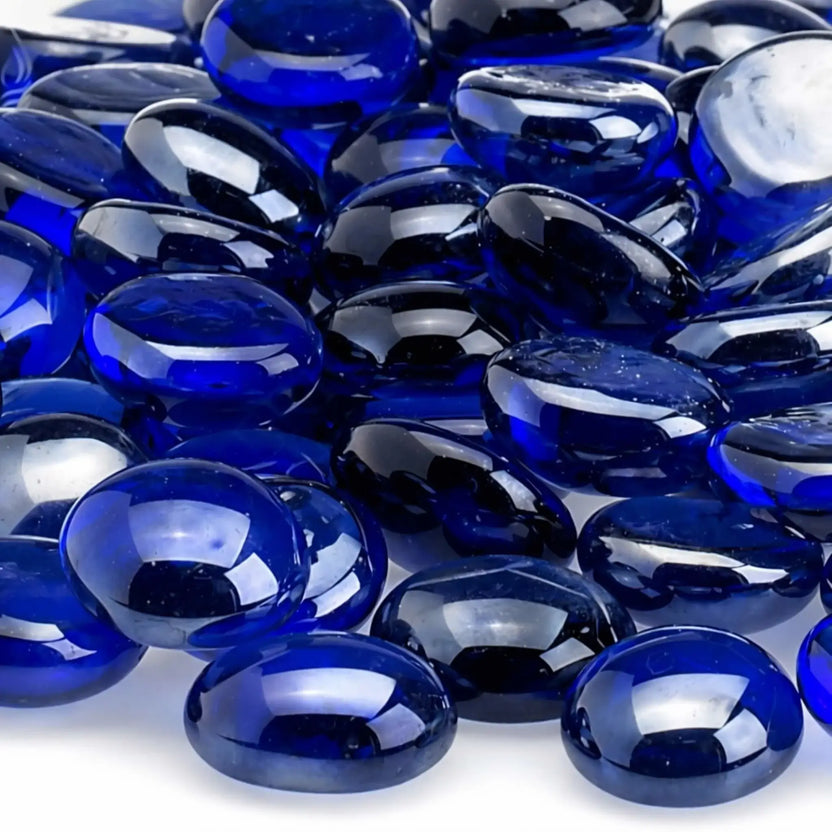 Close-up of royal blue luster fire glass beads highlighting their translucent cobalt color, polished rounded edges, reflective surface, and tempered glass construction.