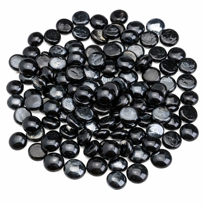 Overhead view of twilight black luster fire glass beads arranged in a rounded pile, highlighting the smooth drop shape, glossy black finish, and subtle reflective sheen.