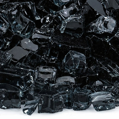 Macro close-up of 1/2 inch non-reflective black tempered fire glass pieces, showing glossy dark surfaces with softened edges and subtle light reflections, designed for contemporary gas fire pit media.