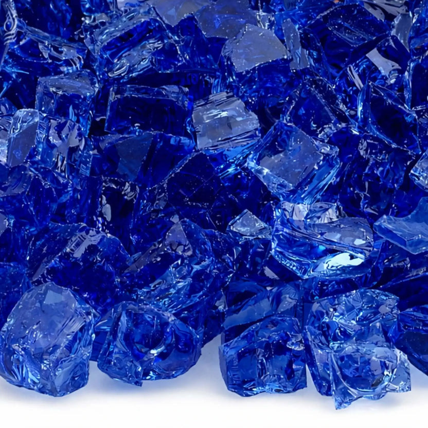 Close-up of cobalt blue 1/2 inch non-reflective tempered fire glass pieces, showing vibrant deep blue color, polished surfaces, and dimensional facets designed to enhance flame appearance in modern gas fireplaces.