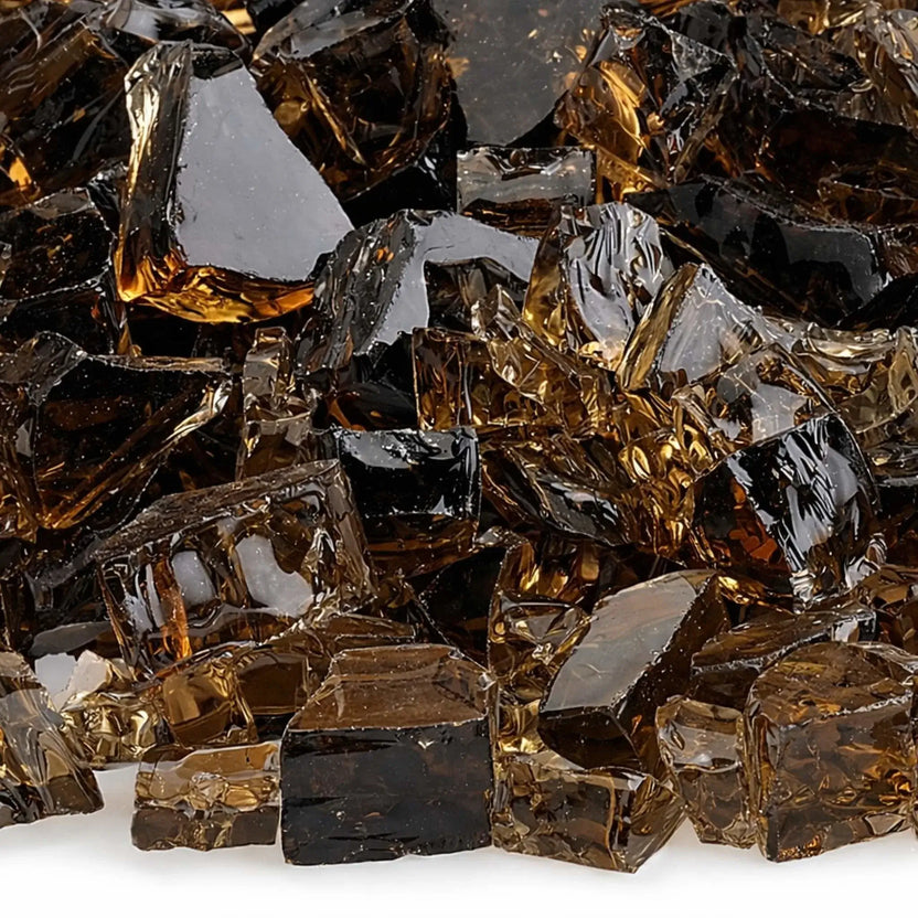 Close-up detail of 1/2 inch non-reflective copper tempered fire glass, highlighting the blend of translucent golden brown and darker bronze pieces with smooth, broken edges designed to enhance flame reflection in contemporary gas fireplaces.