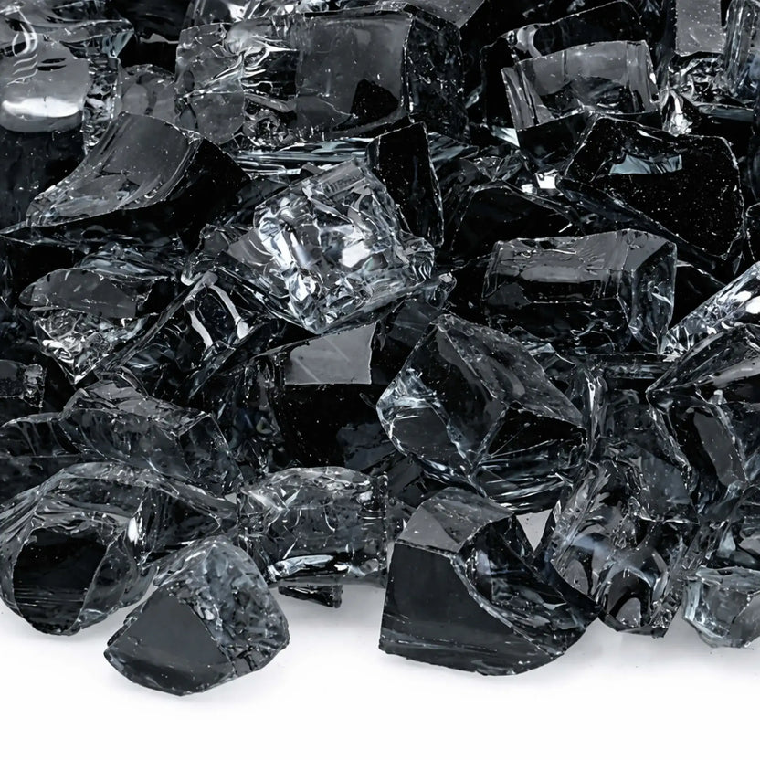 Macro close-up of gray 1/2 inch non-reflective tempered fire glass pieces, showing layered smoky tones, subtle transparency, and polished surfaces designed to reduce glare while enhancing flame presentation in gas fire features.