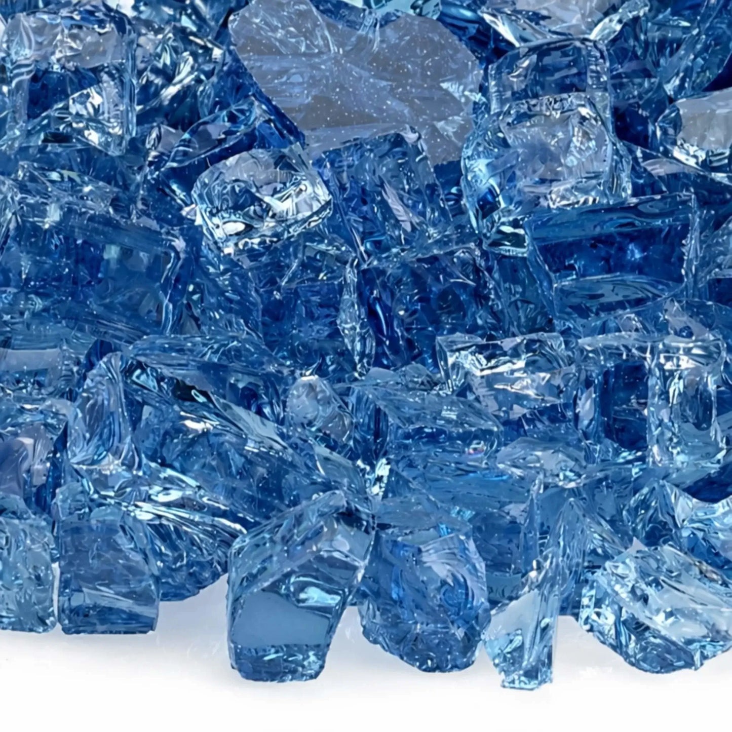 Close-up view of American Fire Products 1/2 inch Classic Non-Reflective Pacific Blue tempered fire glass, showcasing a mix of deep ocean blue and lighter aqua tones with smooth, tumbled edges and translucent depth designed to enhance flame movement in modern gas fire pits.