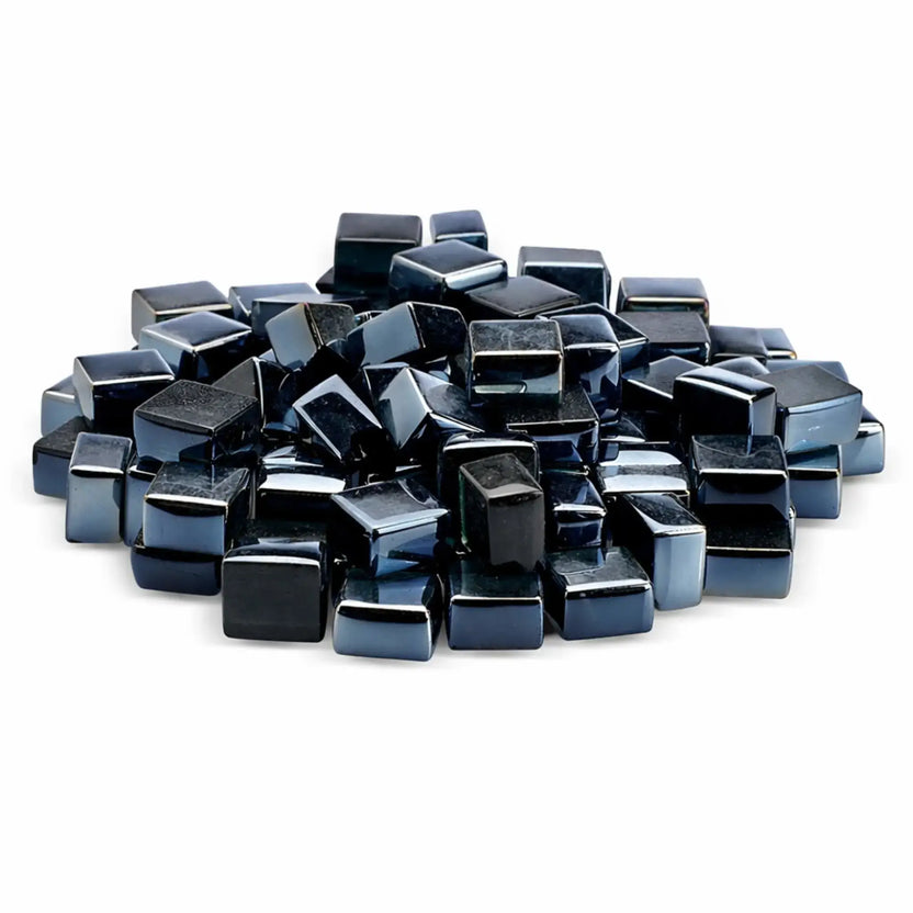 A close-up view of glossy black tempered glass fire pit cubes in a 1/2-inch size, featuring a reflective luster finish. The smooth, polished cube shapes are piled together against a clean white background, highlighting their deep black color and mirror-like shine; ideal for modern gas fire pits and fireplaces.