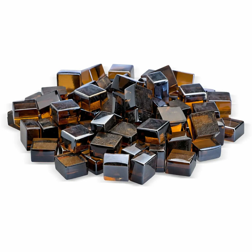 Studio product image of copper Luster 2.0 half-inch tempered fire glass cubes from American Fire Products, stacked in a mound against a clean white backdrop. The rich amber and copper hues shimmer through the translucent glass, giving the cubes a warm, glowing appearance ideal for modern fire features.