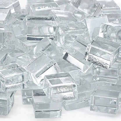 Detailed close-up of Starfire clear white tempered fire glass cubes highlighting their smooth, polished edges and crystal-clear transparency. Subtle internal reflections and textured undersides add dimension and brilliance to the glass pieces.