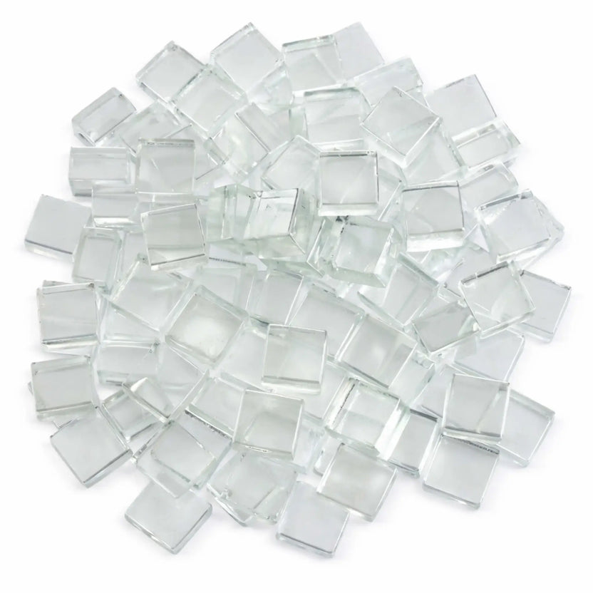 Top-down view of Starfire clear white half-inch tempered fire glass cubes arranged in a loose circular pile on a white surface. The clear, ice-like cubes display a smooth, reflective finish that adds sparkle and modern appeal to gas fire pits and fireplaces.