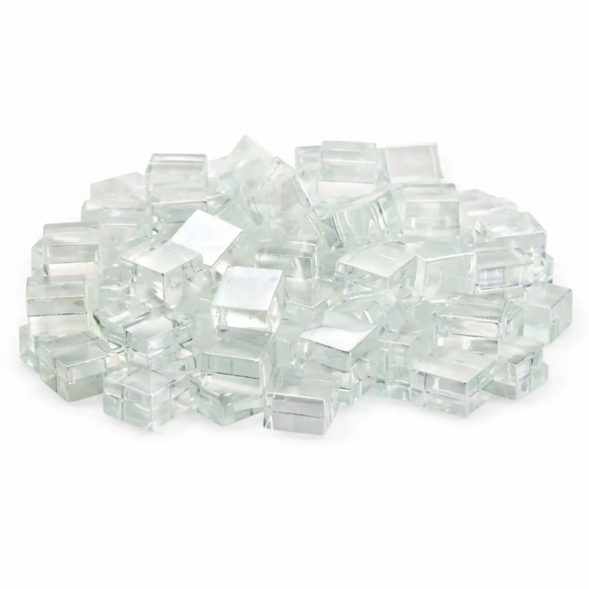 Studio image of Starfire clear white Luster 2.0 half-inch tempered fire glass cubes stacked in a mound against a bright white backdrop. The transparent cubes feature a crisp, icy appearance with high-gloss surfaces that reflect light beautifully.