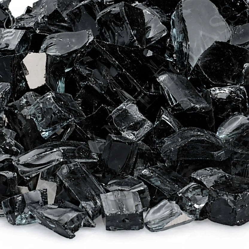 Detailed close-up of 1/2 inch premium reflective black tempered fire glass by American Fire Products, showcasing the sharp-edged, high-gloss fragments with mirrored surfaces that intensify flame reflection and create a dramatic fire feature look.