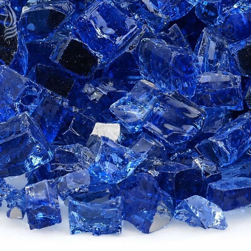 Detailed macro image of 1/2 inch premium reflective cobalt blue tempered fire glass by American Fire Products, showcasing the intense sapphire blue color, smooth polished surfaces, and reflective coating that enhances light and flame reflection.