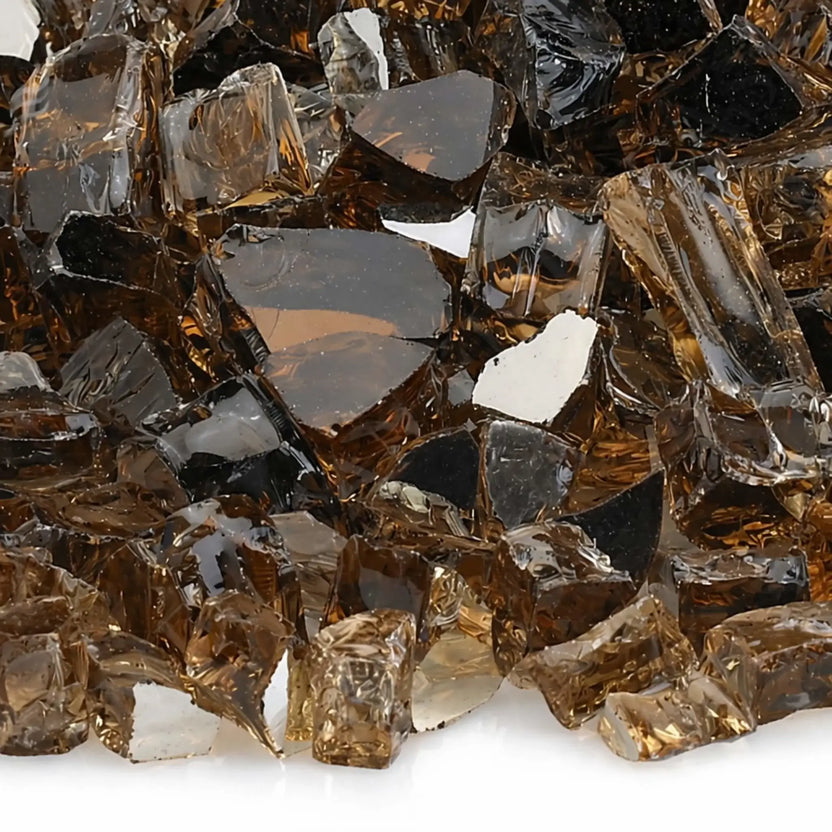 Close-up of 1/2 inch premium reflective copper tempered fire glass by American Fire Products, showing the glossy amber and smoky hues, sharp angular fragments, and reflective backing that intensifies fire pit flames.